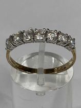 9CT GOLD RING set with band of seven cubic zirconia, size S-T, 1.7gms Provenance: deceased estate