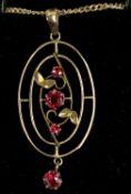 9CT GOLD OVAL PENDANT, floral open work and set with three rubies, on fine link chain, 44cms (l),