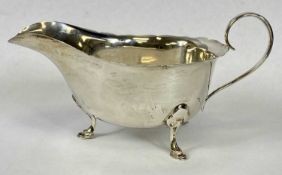 ELIZABETH II SILVER SAUCE BOAT, with wavy rim, loop handle and on hoof feet, Sheffield 1962,