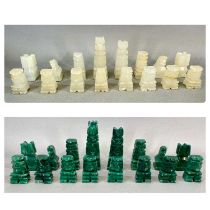 AUSTRALIAN GREEN & WHITE CARVED ONYX CHESS SET, of Aztec design, 32 pieces Provenance: private