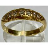18CT GOLD RING, set with a band of seven small diamonds, size P-O, 3.5gms Provenance: private