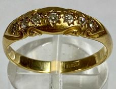 18CT GOLD RING, set with a band of seven small diamonds, size P-O, 3.5gms Provenance: private