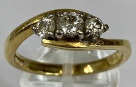 GOLD THREE STONE DIAMOND CROSSOVER RING, size T, 5.3gms Provenance: deceased estate Carmarthenshire