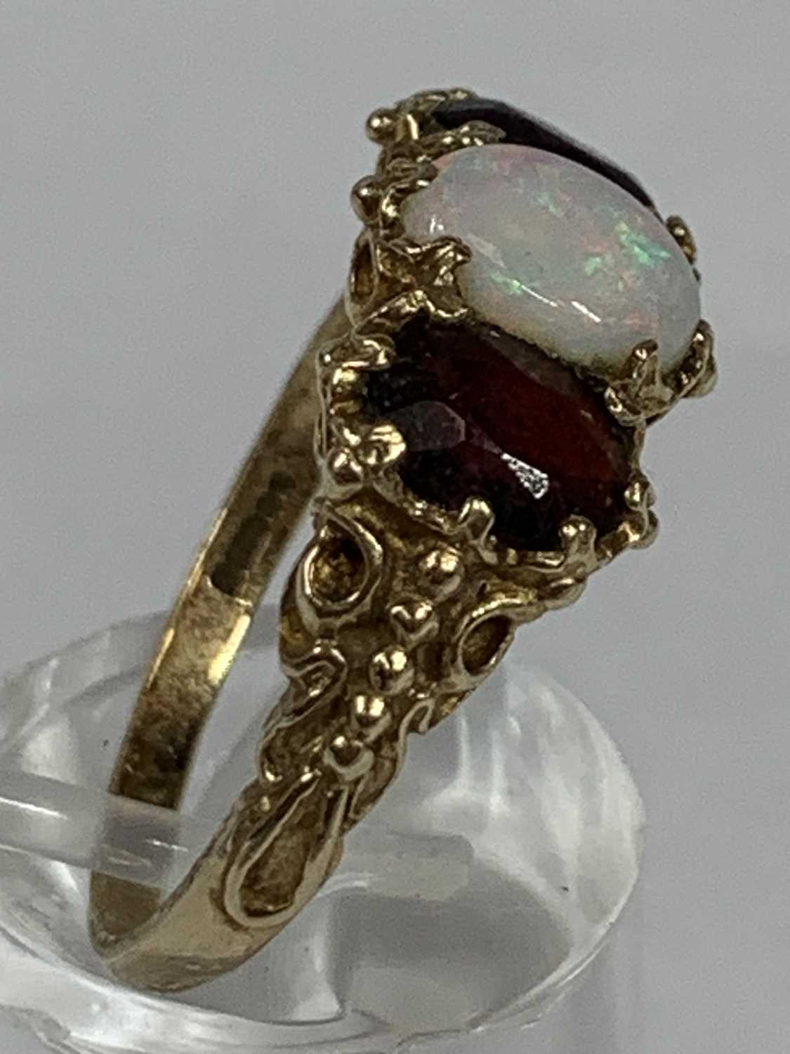 9CT GOLD RING set with oval opal, flanked by oval garnets, size S, 4.0gms Provenance: deceased - Image 2 of 2