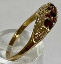 9CT GOLD RING, set with band of seven rubies, with chased mount, size O, 2.7gms Provenance: