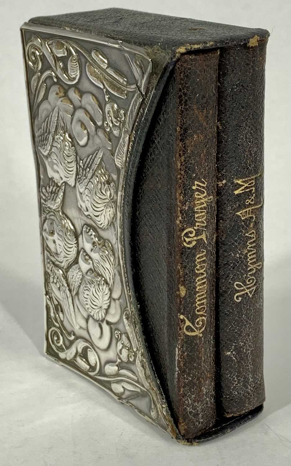 PRAYER & HYMN BOOKS WITH SILVER COVER, embossed with cherubs, heads and scrolls, containing