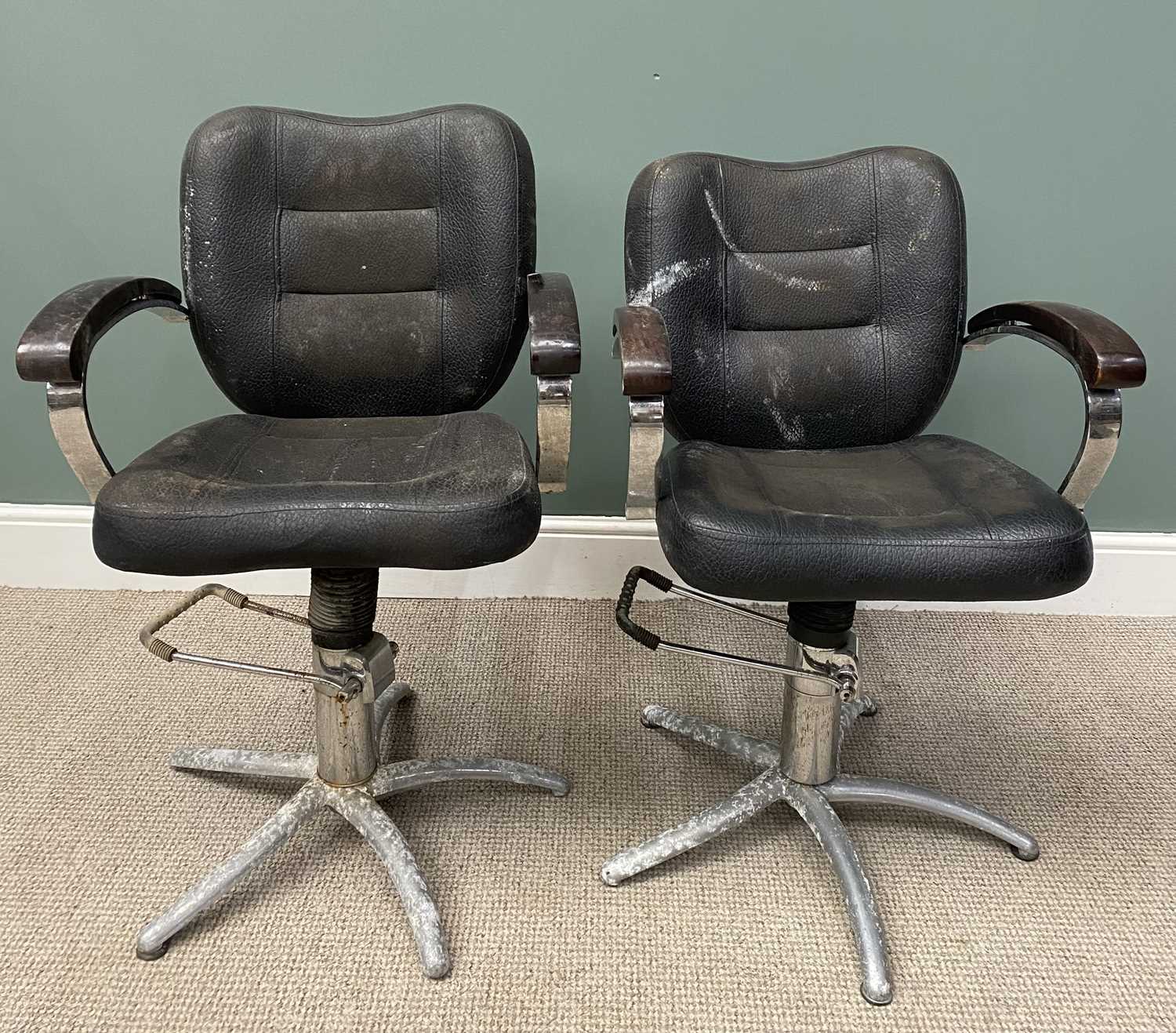 TWO VINTAGE ADJUSTABLE BARBERS' CHAIRS 99 (h) x 60 (w) x 44cms (d) Provenance: private collection
