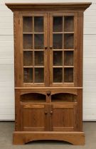 LARGE PITCH PINE CORNER CUPBOARD having two upper glazed doors, two base doors, 235 (h) x 115 (w)