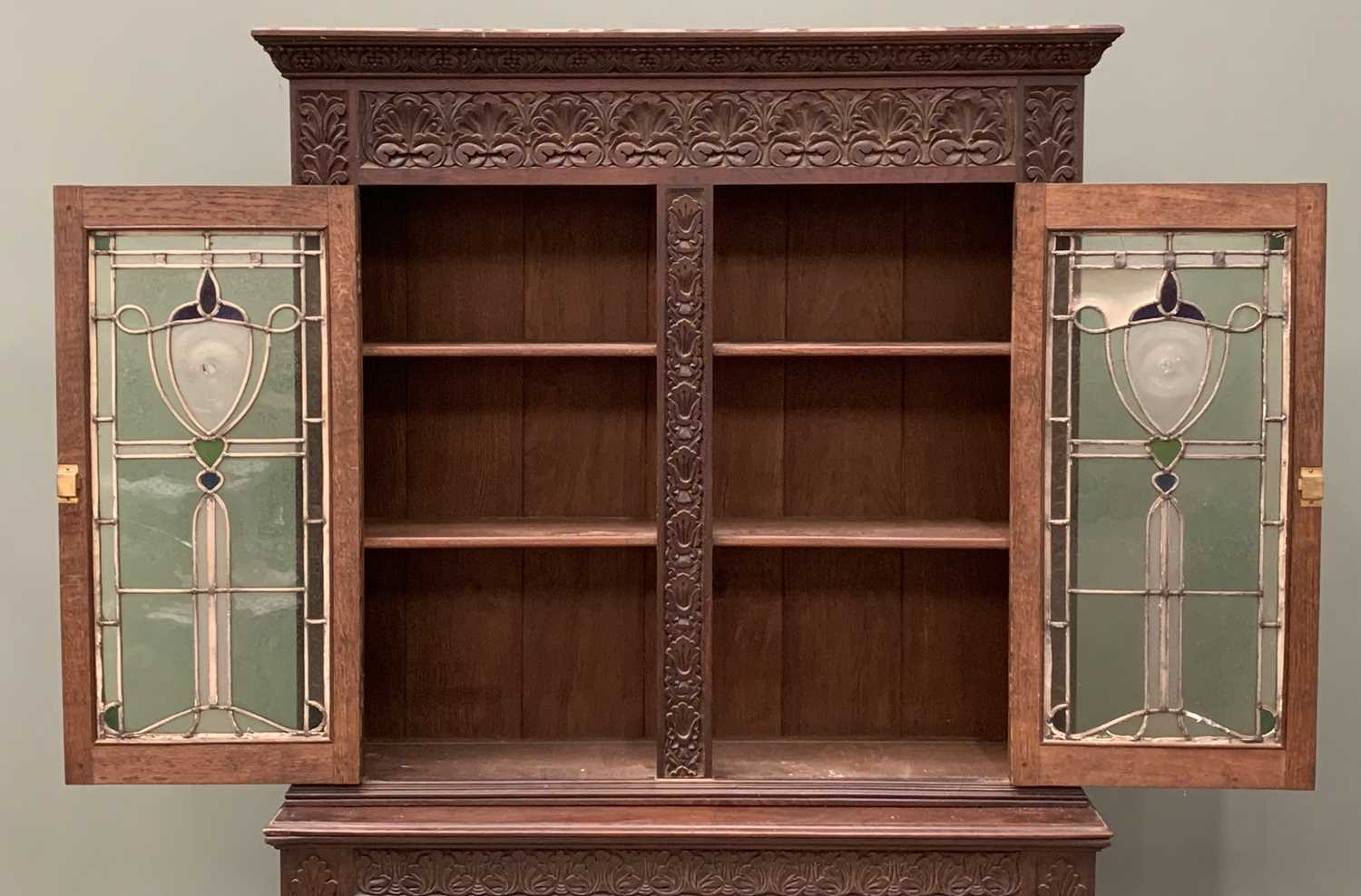 EDWARDIAN CARVED OAK BOOKCASE circa 1900, having an open two shelf base, below elaborately leaded - Image 2 of 5