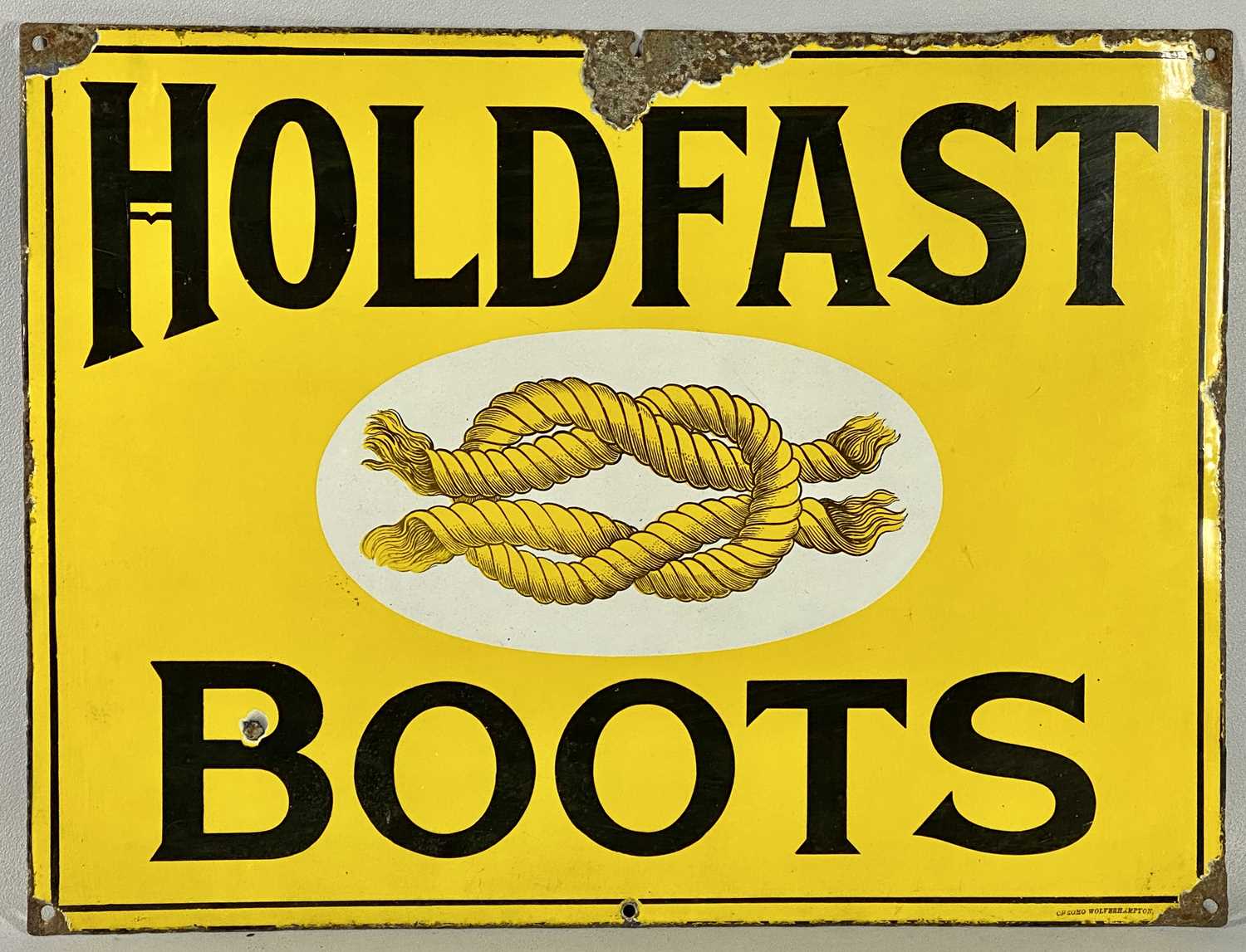 VINTAGE ENAMEL ADVERTISING SIGN FOR HOLDFAST BOOTS with black lettering and single line border,