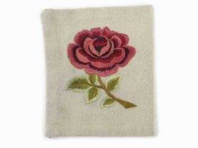 A SPARE ENGLAND INTERNATIONAL RUGBY UNION JERSEY BADGE CIRCA 1908 with embroidered English rose from