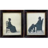 PAIR OF ANTIQUE SILHOUETTES, a seated lady and a seated gentleman with a canine companion, gilt