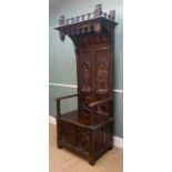 GOTHIC STYLE CARVED OAK HIGH BACK ARMCHAIR, with box seat, decorated in the medieval style with