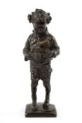 A SCOTTISH BRONZE SCULPTURE OF A YOUNG BOY AFFIXING A MILITARY BELT TO WAIST the boy modelled with