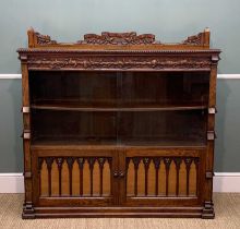 LATE 19TH C. GOTHIC REVIVAL OAK BOOKCASE, vine leaf carved frieze below dentil moulded top with