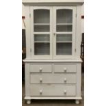 ANTIQUE PANTED PINE BOOKCASE CUPBOARD having twin glazed doors over a chest of two short over two