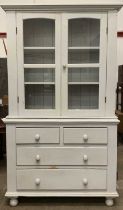 ANTIQUE PANTED PINE BOOKCASE CUPBOARD having twin glazed doors over a chest of two short over two