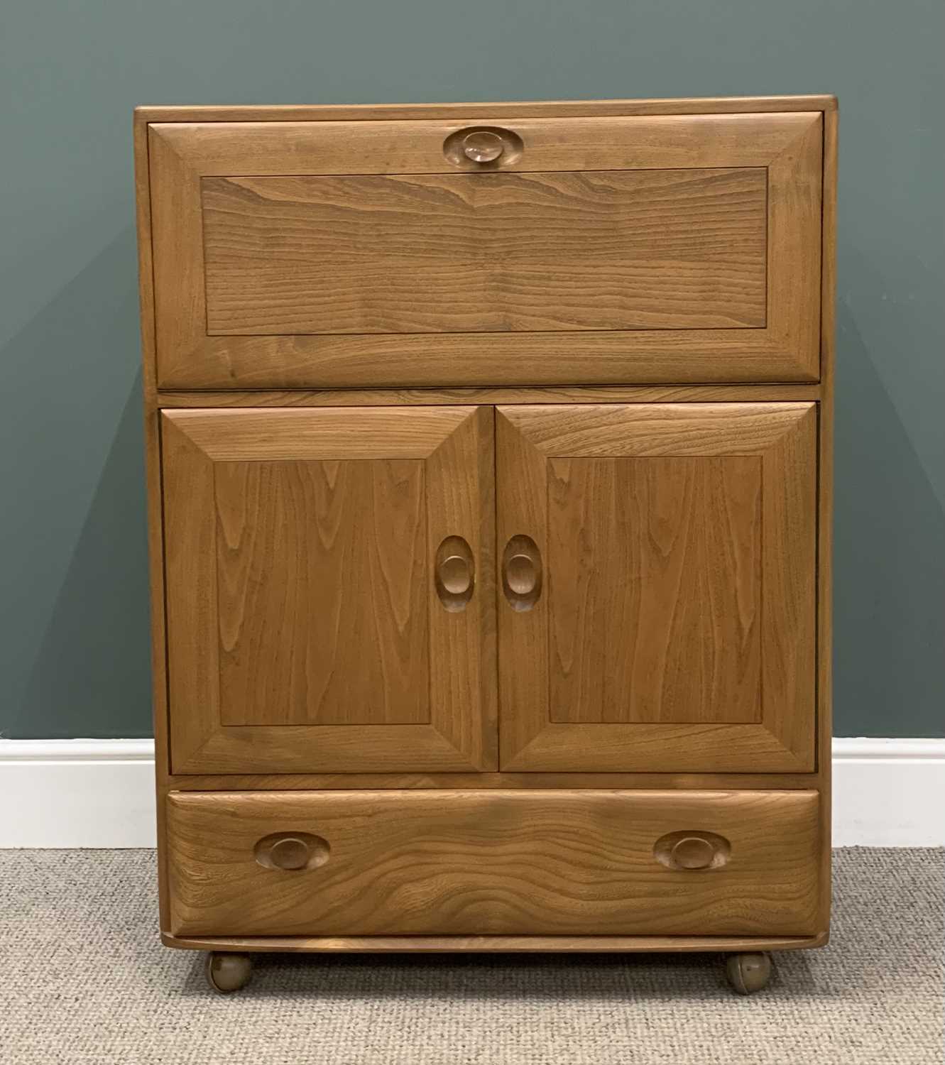 LIGHT ERCOL BUREAU with fall front top over two cupboards doors and a base drawer, 110 (h) x 82 (
