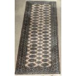 CARPET RUNNER by Frith, brown and green ground with repeating diamond pattern, 250 x 84cms