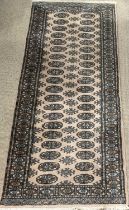 CARPET RUNNER by Frith, brown and green ground with repeating diamond pattern, 250 x 84cms