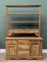 VINTAGE PINE DRESSER with open three shelf rack and spice drawers, the base with carved doors,