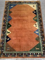 MODERN WOOLLEN RUG, ground rust coloured and multi-patterned, 185 x 120cms Provenance: Private