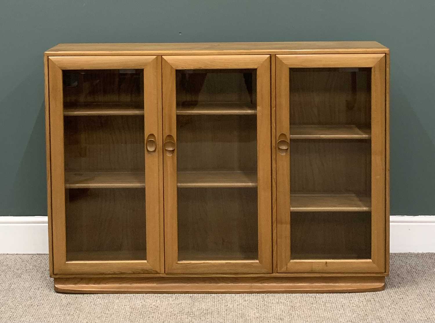LIGHT ERCOL THREE DOOR BOOKCASE, 97 (h) x 136 (w) x 29 (d) cms Provenance: Private collection