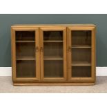 LIGHT ERCOL THREE DOOR BOOKCASE, 97 (h) x 136 (w) x 29 (d) cms Provenance: Private collection