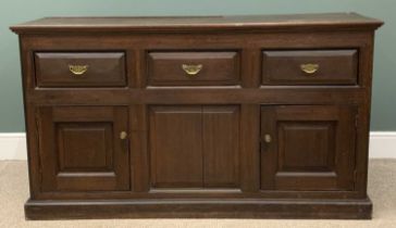 OAK DRESSER BASE circa 1900 and having three drawers over two cupboard doors with fielded panels, 90