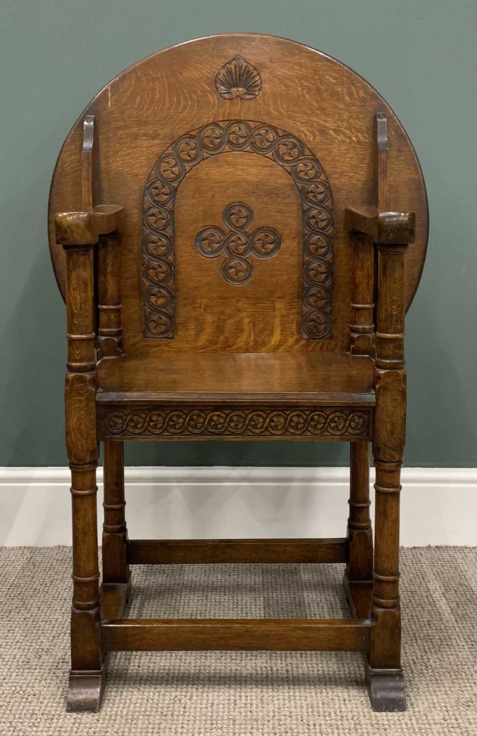 EARLY 20th CENTURY OAK MONK'S BENCH/CHAIR with circular carved top, 74 (h) x 69 (diam) cms