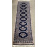 CARPET RUNNER, blue ground with eight central medallions, 220 x 63cms Provenance: Private collection