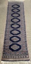 CARPET RUNNER, blue ground with eight central medallions, 220 x 63cms Provenance: Private collection