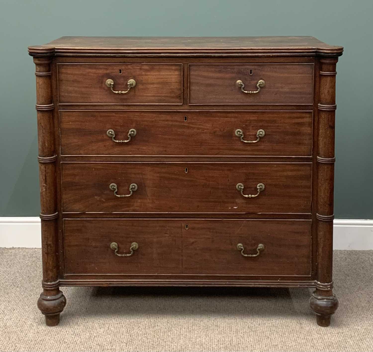 GEORGIAN MAHOGANY CHEST of two over three drawers with brass drop handles, pillar sides and bun