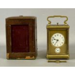 GILT BRASS CASED CARRIAGE ALARM CLOCK, late 19th/early 20th century, circular white enamel dial with