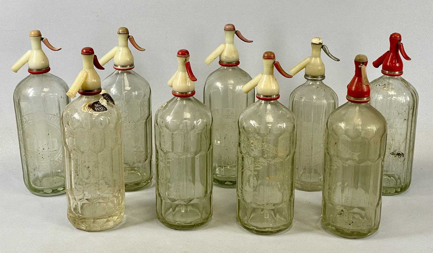 NINE VINTAGE GLASS SODA SYPHONS, facet and ribbed glass, etched advertising detail, Hooper Struve, - Image 2 of 8