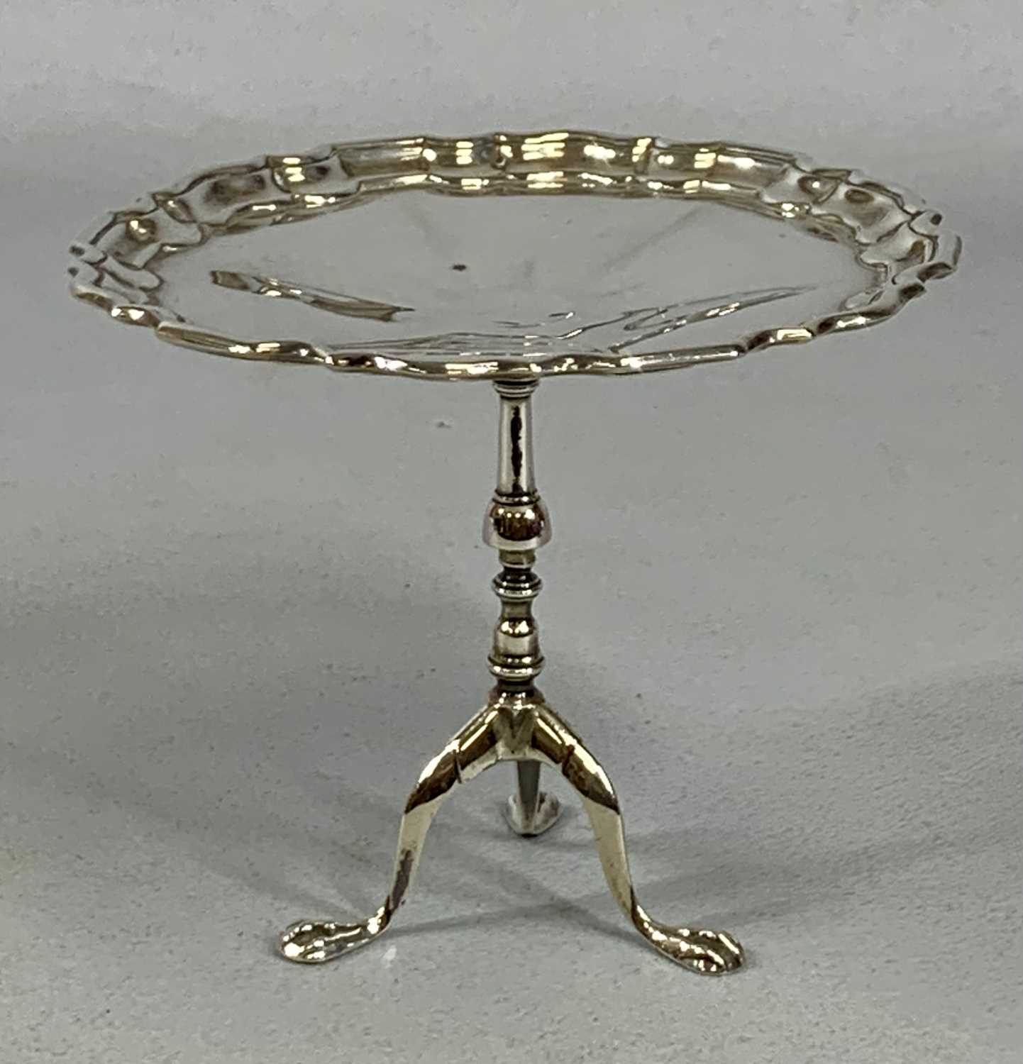 GEORGE V SILVER SWEET MEAT DISH, in the form of a tripod table with pie crust top, Birmingham