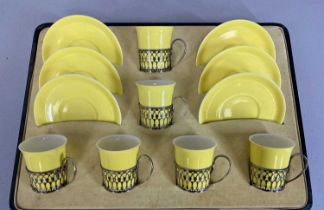 CASED SHELLEY SILVER MOUNTED YELLOW GLAZED COFFEE SERVICE, of six cups and six saucers, the