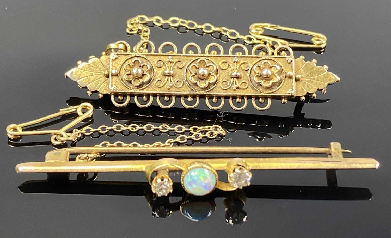 TWO YELLOW METAL BAR BROOCHES, one set with a central opal flanked by four small diamonds, with