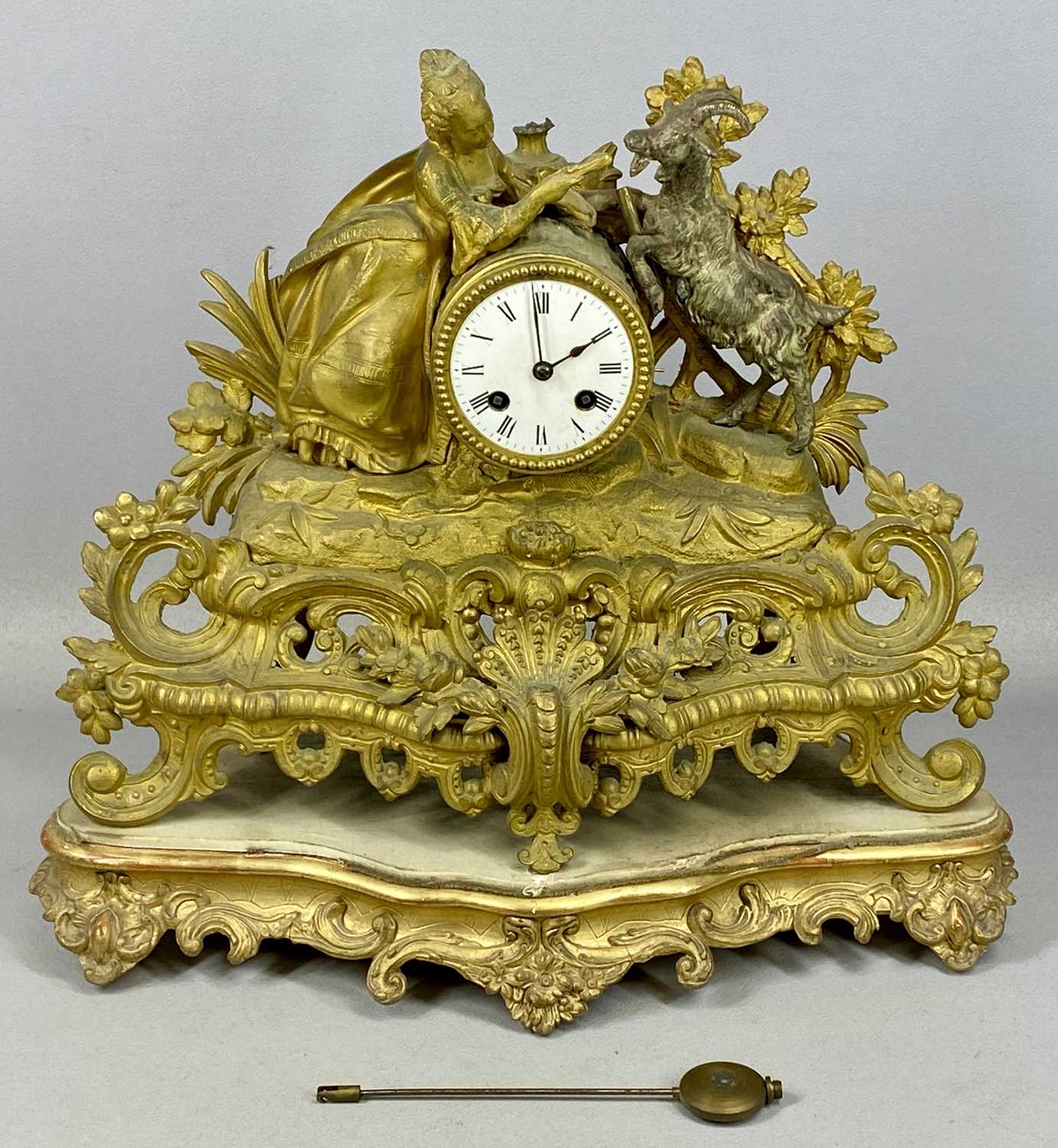 GILDED SPELTER MANTEL CLOCK, late 19th century, barrel dial surmounted with a figure of a female