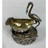 VICTORIAN/EDWARDIAN CONTINENTAL CAST SILVER OPEN SALT, in the form of stork with baby by crib,