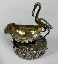 VICTORIAN/EDWARDIAN CONTINENTAL CAST SILVER OPEN SALT, in the form of stork with baby by crib,