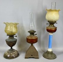 GROUP OF THREE OIL LAMPS, late 19th century & later, the first with embossed brass base, blue