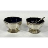 GEORGE V HEXAGONAL SILVER OPEN SALTS A PAIR, with blue glass liners and a single silver spoon,