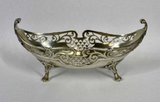 GEORGE VI OVAL SILVER BON BON DISH, with scrolled terminals, pierced sides on four pad feet,
