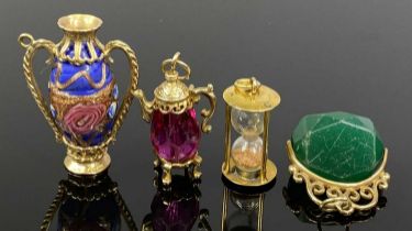 GOLD MOUNTED GREEN HARDSTONE SWIVEL FOB & THREE 9CT GOLD CHARMS, one modelled as an egg timer