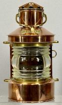 SHIP'S COPPER TOP LIGHT with brass mounts and swing handle, with burner, 32cms (h) Provenance: