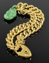 GOLD CURB LINK BRACELET, with heart shaped padlock marked 15ct, with a jade type charm attached,