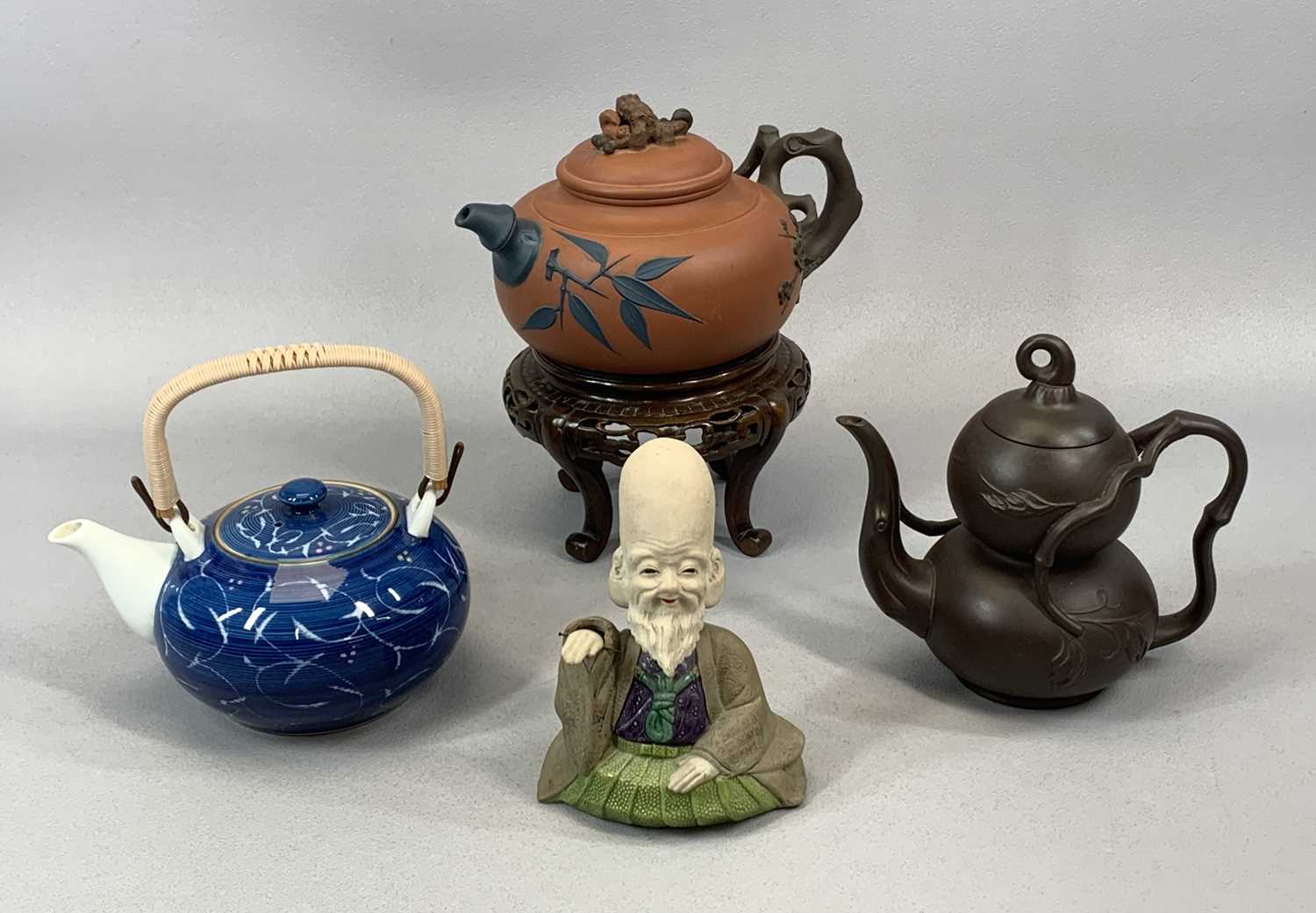 MIXED GROUP OF ORIENTAL CERAMICS including a terracotta teapot, decorated in relief with flowers and