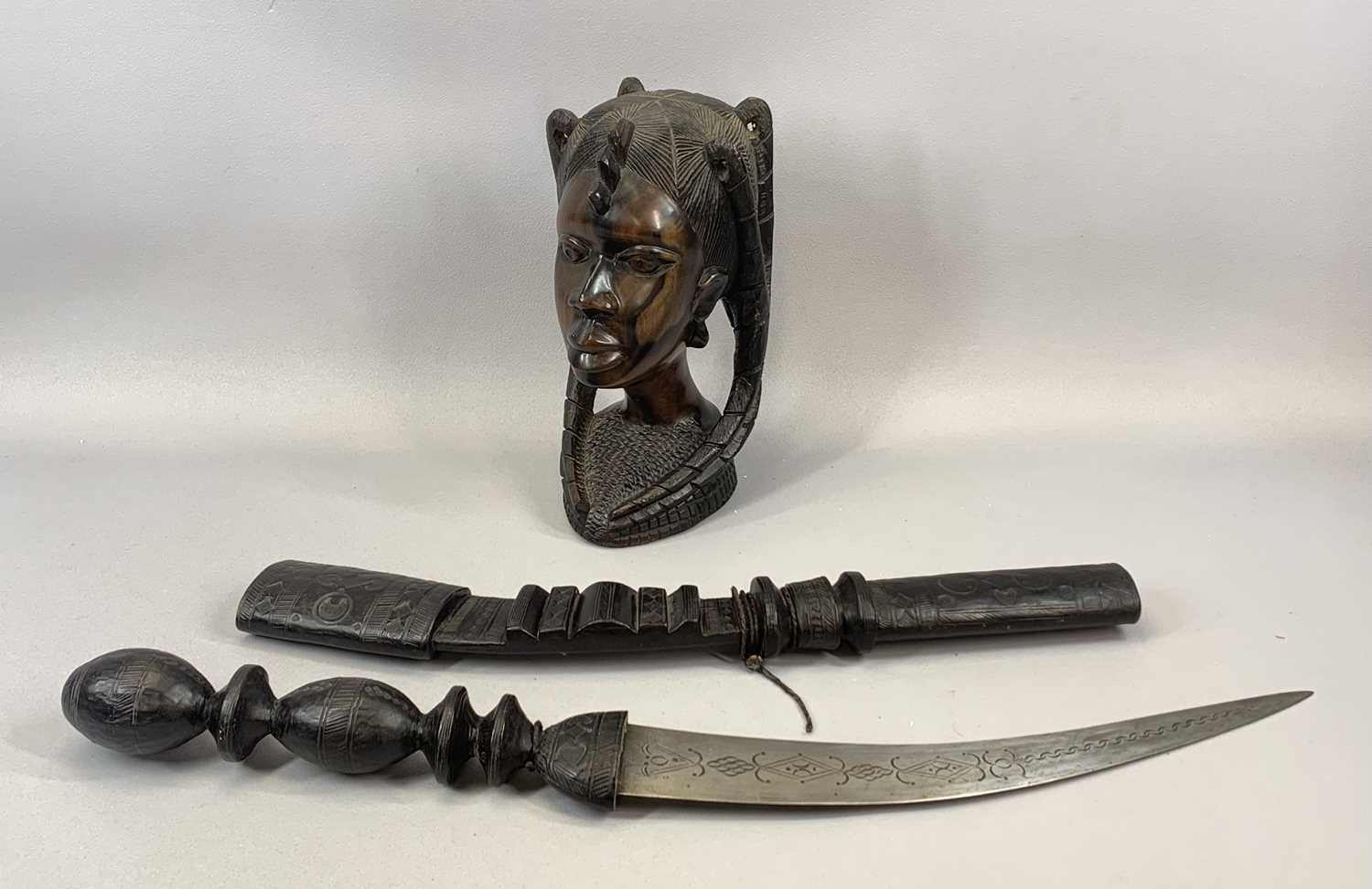 NIGERIAN CARVED HARDWOOD BUST OF A LADY, 29cms (h), a Nigerian curved sword in carved sheath,