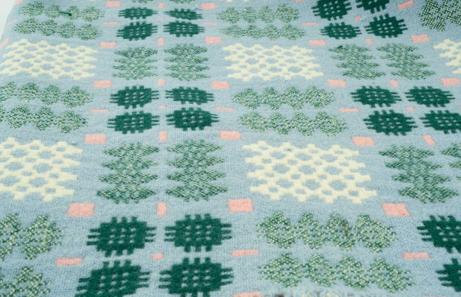 TRADITIONAL WELSH WOOLEN BLANKET of geometric design, pale blue ground with white, pink and green